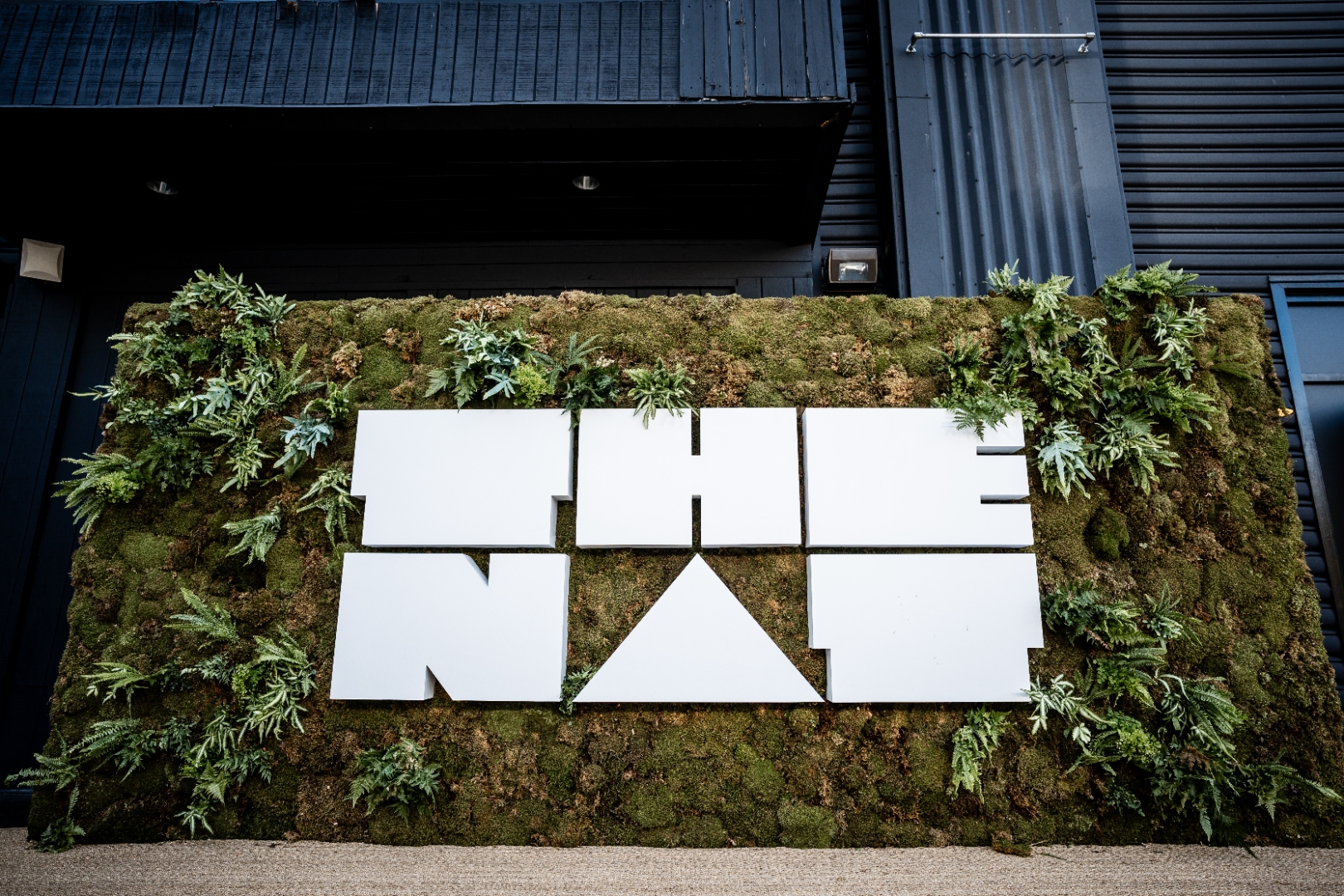 THE NAT branded moss wall installation with the logo at THE NAT GALA