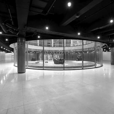 Black and white interior of Halo 28's curved glass-walled event space in New York